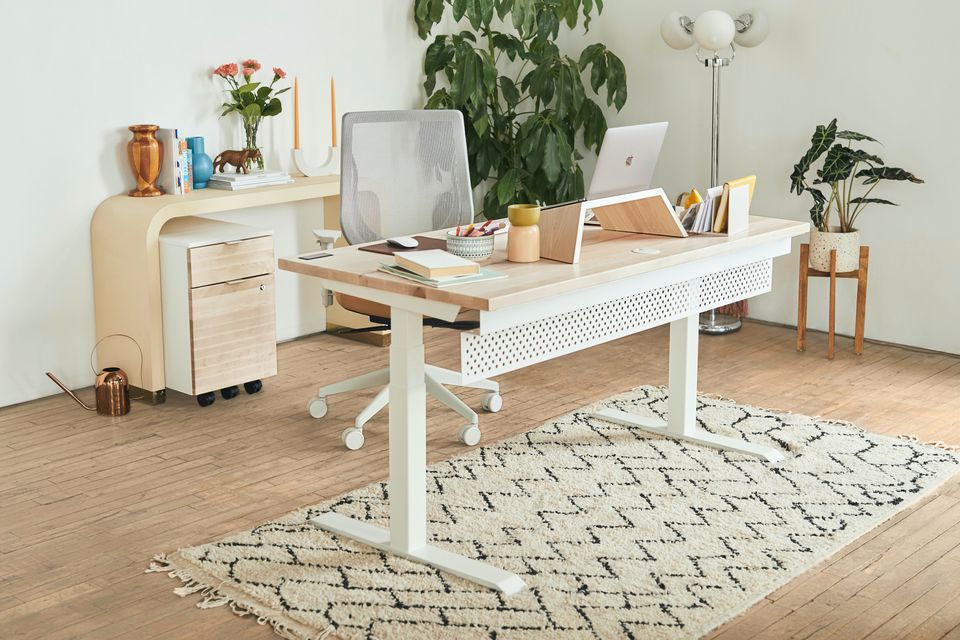 A laptop sitting on a desk in a home office environment.